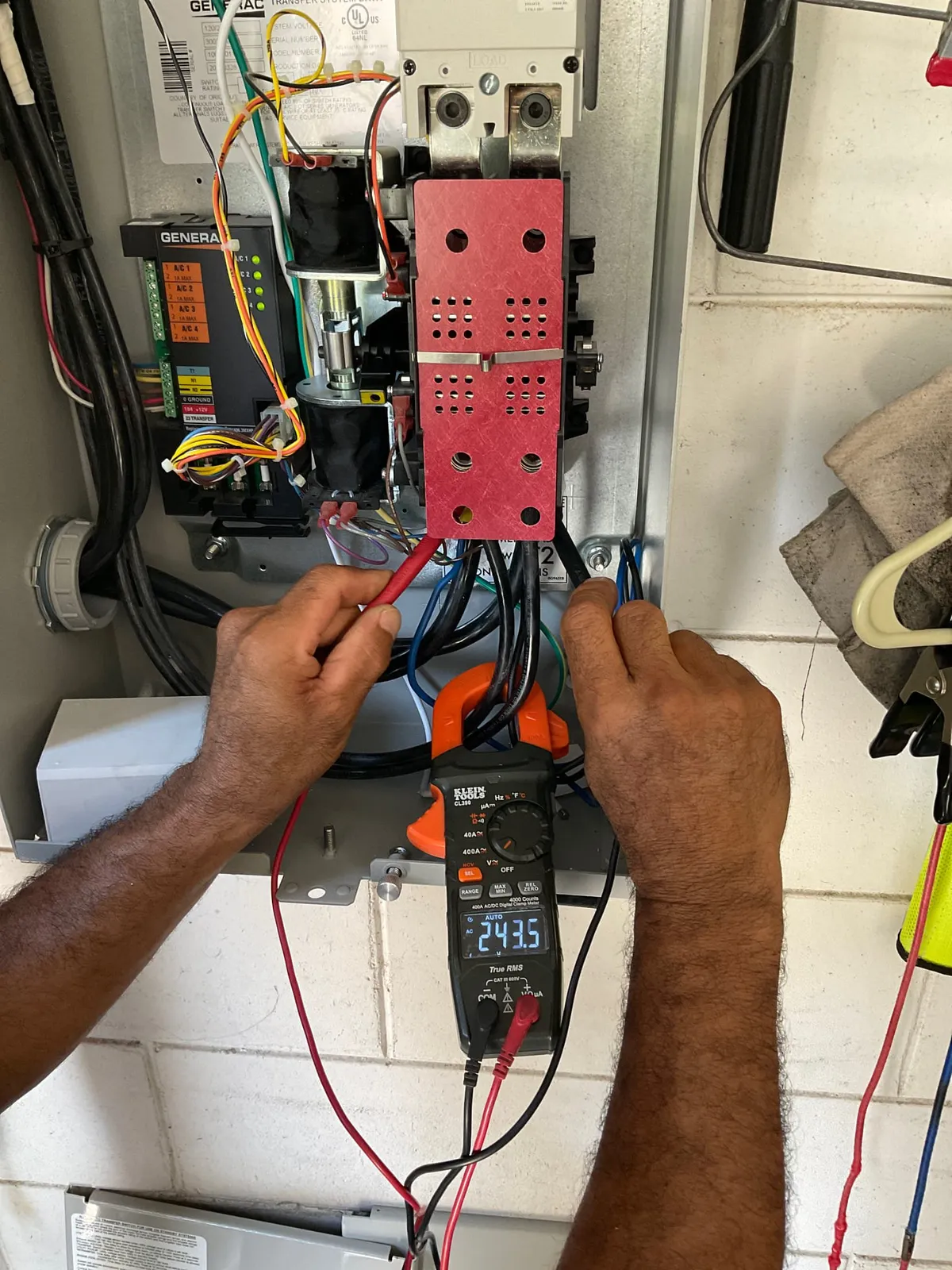 Top Flight electrician testing electrical equipment with a multimeter